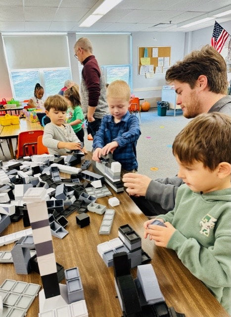 Children exploring building materials during a classroom playtest