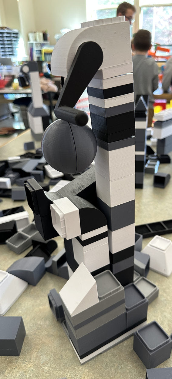 Tall monochrome windmill constructed during a playtest