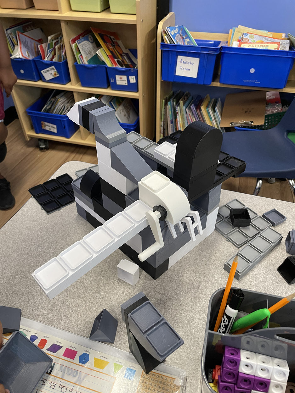 An animal-like black-and-white construction on a classroom desk